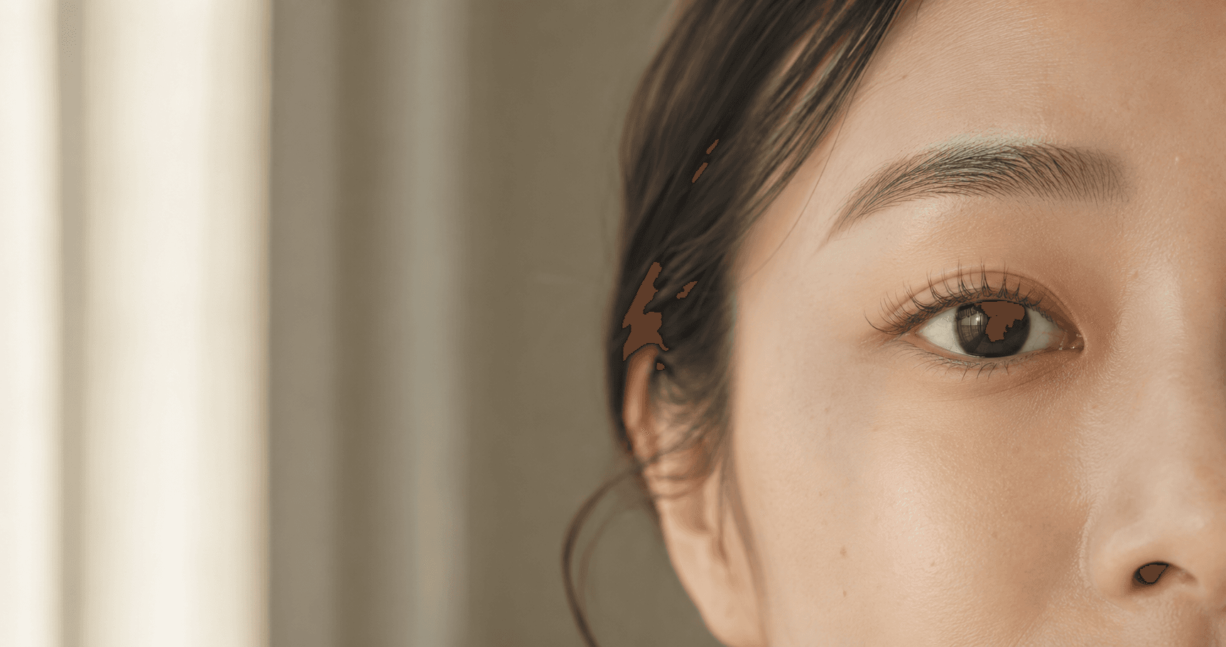 Close detail of lifted lashes in warm studio light